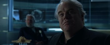 Movie still from “The Hunger Games: Catching Fire” (2013), directed by Francis Lawrence – A man that is looking into the camera; Close Up shot, Over the shoulder angle