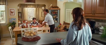 Movie still from “Diary of a Wimpy Kid: Dog Days” (2012), directed by David Bowers – A man and a woman are sitting at a dining table; Medium shot, Over the shoulder angle