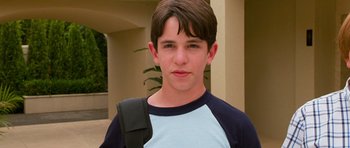 Movie still from “Diary of a Wimpy Kid: Dog Days” (2012), directed by David Bowers – A young boy with a backpack on his shoulder; Close Up shot, High angle
