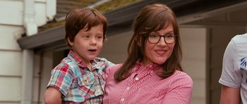 Movie still from “Diary of a Wimpy Kid: Dog Days” (2012), directed by David Bowers – A woman and a boy are smiling for the camera; Close Up shot, Over the shoulder angle