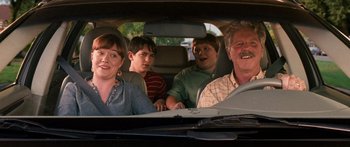 Movie still from “Diary of a Wimpy Kid: Dog Days” (2012), directed by David Bowers – A group of people sitting in the back of a car; Medium shot, Over the shoulder angle