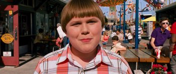Movie still from “Diary of a Wimpy Kid: Dog Days” (2012), directed by David Bowers – A young boy with a checkered shirt is posing for a picture; Close Up shot, High angle