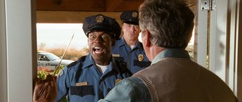 Movie still from “Diary of a Wimpy Kid: Dog Days” (2012), directed by David Bowers – A group of men in police uniforms talking to each other; Medium shot, Low angle