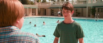 Movie still from “Diary of a Wimpy Kid: Dog Days” (2012), directed by David Bowers – A boy standing in the pool; Medium shot, Over the shoulder angle