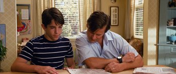 Movie still from “Diary of a Wimpy Kid: Dog Days” (2012), directed by David Bowers – A man and a young boy looking at papers; Medium shot, Over the shoulder angle