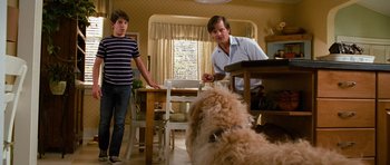 Movie still from “Diary of a Wimpy Kid: Dog Days” (2012), directed by David Bowers – Two people and a dog in a room; Medium shot, Over the shoulder angle