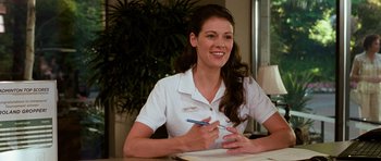 Movie still from “Diary of a Wimpy Kid: Dog Days” (2012), directed by David Bowers – A woman sitting at a table writing on a piece of paper; Medium shot, Over the shoulder angle