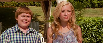 Movie still from “Diary of a Wimpy Kid: Dog Days” (2012), directed by David Bowers – A girl with long blonde hair standing next to a boy; Medium shot, Over the shoulder angle