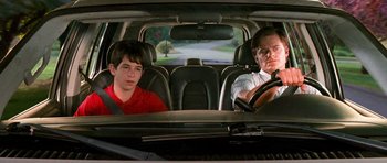 Movie still from “Diary of a Wimpy Kid: Dog Days” (2012), directed by David Bowers – A man and a boy sitting in the back seat of a car; Medium shot, Over the shoulder angle