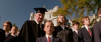 Movie still from “Diary of a Wimpy Kid: Dog Days” (2012), directed by David Bowers – A man and a woman and a young boy in front of a castle; Medium shot, Low angle