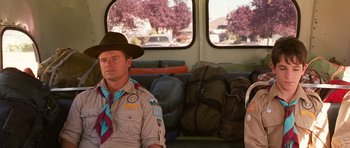 Movie still from “Diary of a Wimpy Kid: Dog Days” (2012), directed by David Bowers – A boy scout sitting on the back of a bus; Medium shot, Over the shoulder angle