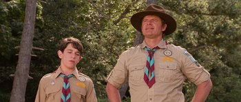 Movie still from “Diary of a Wimpy Kid: Dog Days” (2012), directed by David Bowers – A man and a young boy wearing scout uniforms; Medium shot, Low angle