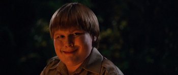 Movie still from “Diary of a Wimpy Kid: Dog Days” (2012), directed by David Bowers – A young boy with a brown shirt and a smile; Close Up shot, Low angle