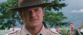 Movie still from “Diary of a Wimpy Kid: Dog Days” (2012), directed by David Bowers – A person wearing a hat with trees in the background; Close Up shot, Over the shoulder angle