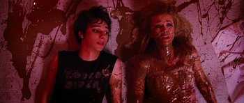 Movie still from “Diary of a Wimpy Kid: Dog Days” (2012), directed by David Bowers – Two young people are covered in red paint; Medium shot, Overhead angle
