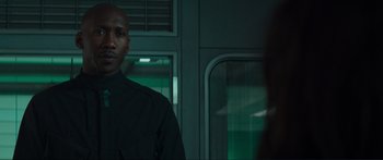 Movie still from “The Hunger Games: Mockingjay - Part 1” (2014), directed by Francis Lawrence – A man standing next to a woman in front of a window; Close Up shot, Over the shoulder angle