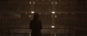 Movie still from “The Hunger Games: Mockingjay - Part 1” (2014), directed by Francis Lawrence – A woman standing in front of a wall of people; Wide shot, High angle