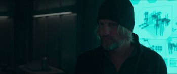 Movie still from “The Hunger Games: Mockingjay - Part 1” (2014), directed by Francis Lawrence – A man with long blonde hair and a beard; Close Up shot, Over the shoulder angle