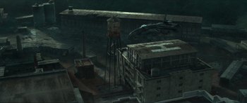 Movie still from “The Hunger Games: Mockingjay - Part 1” (2014), directed by Francis Lawrence – An aerial view of an abandoned building with water towers; Extreme Wide shot, High angle