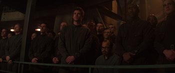 Movie still from “The Hunger Games: Mockingjay - Part 1” (2014), directed by Francis Lawrence – A group of people standing in front of a building; Medium shot, Low angle