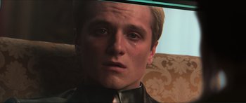 Movie still from “The Hunger Games: Mockingjay - Part 1” (2014), directed by Francis Lawrence – A person with a crying face; Close Up shot, Over the shoulder angle