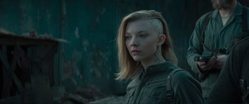 Movie still from “The Hunger Games: Mockingjay - Part 1” (2014), directed by Francis Lawrence – A woman with a tattoo on her head; Close Up shot, Over the shoulder angle