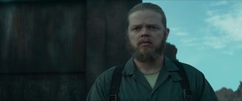 Movie still from “The Hunger Games: Mockingjay - Part 1” (2014), directed by Francis Lawrence – A man with a long beard and a mustache; Close Up shot, Low angle