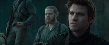 Movie still from “The Hunger Games: Mockingjay - Part 1” (2014), directed by Francis Lawrence – Two men are standing in front of each other; Close Up shot, Over the shoulder angle