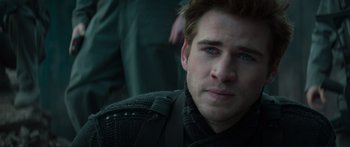 Movie still from “The Hunger Games: Mockingjay - Part 1” (2014), directed by Francis Lawrence – A person wearing a sweater; Close Up shot, Over the shoulder angle