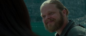 Movie still from “The Hunger Games: Mockingjay - Part 1” (2014), directed by Francis Lawrence – A person with a beard; Close Up shot, Over the shoulder angle