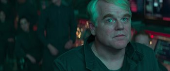 Movie still from “The Hunger Games: Mockingjay - Part 1” (2014), directed by Francis Lawrence – A person with white hair; Close Up shot, Over the shoulder angle