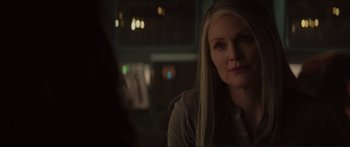 Movie still from “The Hunger Games: Mockingjay - Part 1” (2014), directed by Francis Lawrence – A woman sitting in front of a mirror in a dark room; Close Up shot, Over the shoulder angle