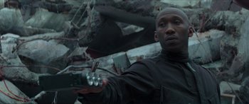 Movie still from “The Hunger Games: Mockingjay - Part 1” (2014), directed by Francis Lawrence – A man in black shirt holding a remote control; Close Up shot, Low angle