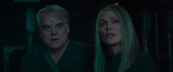 Movie still from “The Hunger Games: Mockingjay - Part 1” (2014), directed by Francis Lawrence – A man and a woman looking at something in the dark; Close Up shot, Over the shoulder angle