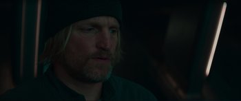 Movie still from “The Hunger Games: Mockingjay - Part 1” (2014), directed by Francis Lawrence – A person wearing a hat; Close Up shot, Over the shoulder angle