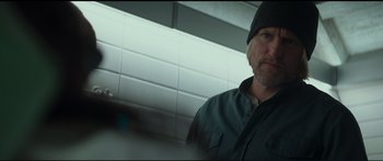 Movie still from “The Hunger Games: Mockingjay - Part 1” (2014), directed by Francis Lawrence – A person wearing a hat and a jacket; Close Up shot, Low angle