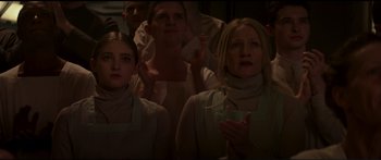 Movie still from “The Hunger Games: Mockingjay - Part 1” (2014), directed by Francis Lawrence – A group of people standing in a room; Medium shot, Low angle