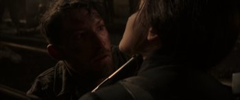 Movie still from “The Hunger Games: Mockingjay - Part 2” (2015), directed by Francis Lawrence – A man and a woman looking into each others eyes; Close Up shot, Over the shoulder angle