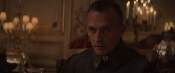 Movie still from “The Hunger Games: Mockingjay - Part 2” (2015), directed by Francis Lawrence – A person wearing a uniform; Close Up shot, Over the shoulder angle