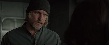 Movie still from “The Hunger Games: Mockingjay - Part 2” (2015), directed by Francis Lawrence – A person wearing a hat; Close Up shot, Over the shoulder angle