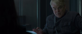Movie still from “The Hunger Games: Mockingjay - Part 2” (2015), directed by Francis Lawrence – A man sitting in front of a computer screen; Close Up shot, Over the shoulder angle