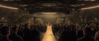 Movie still from “The Hunger Games: Mockingjay - Part 2” (2015), directed by Francis Lawrence – A group of people standing in front of an audience; Extreme Wide shot, High angle