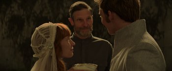 Movie still from “The Hunger Games: Mockingjay - Part 2” (2015), directed by Francis Lawrence – Two men and a woman standing next to each other; Close Up shot, Over the shoulder angle