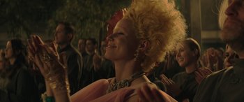 Movie still from “The Hunger Games: Mockingjay - Part 2” (2015), directed by Francis Lawrence – A woman with a very large hair style is looking up; Close Up shot, Low angle