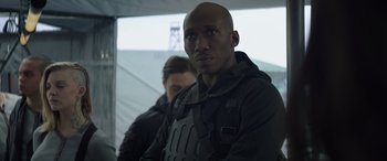 Movie still from “The Hunger Games: Mockingjay - Part 2” (2015), directed by Francis Lawrence – A man in a black jacket and a woman in a black jacket; Close Up shot, Over the shoulder angle