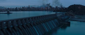Movie still from “The Hunger Games: Mockingjay - Part 2” (2015), directed by Francis Lawrence – A view of a large body of water with a city in the background; Extreme Wide shot, High angle