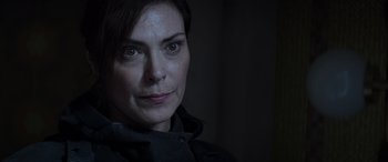 Movie still from “The Hunger Games: Mockingjay - Part 2” (2015), directed by Francis Lawrence – A woman's face in the dark; Close Up shot, Over the shoulder angle