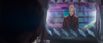 Movie still from “The Hunger Games: Mockingjay - Part 2” (2015), directed by Francis Lawrence – A woman is sitting in front of a television; Close Up shot, Over the shoulder angle