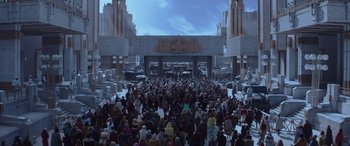 Movie still from “The Hunger Games: Mockingjay - Part 2” (2015), directed by Francis Lawrence – A crowd of people standing in front of a building; Extreme Wide shot, High angle