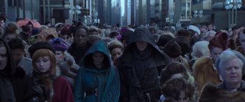 Movie still from “The Hunger Games: Mockingjay - Part 2” (2015), directed by Francis Lawrence – A crowd of people walking down a street; Medium shot, High angle